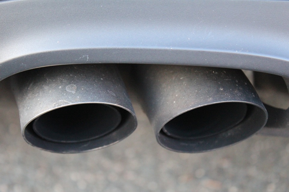 A top down angled image of two tailpipe ports on a grey vehicle for Darrel's Economy Mufflers Blog Article "Three Warning Signs of a Bad Muffler"